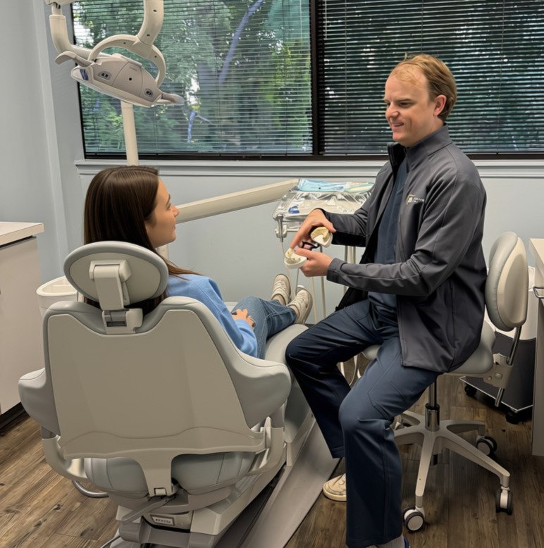 Dr. Dave McCollum, DMD, discussing dental treatment with a patient at McCollum Dental in Conyers, GA